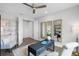Comfortable home office featuring a ceiling fan, black desk, and three decorative mirrors for a relaxing workspace at 855 Emerald Grove Dr, Apopka, FL 32703