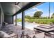 Covered patio offers ample seating with a view of the refreshing inground pool and lush backyard at 855 Emerald Grove Dr, Apopka, FL 32703