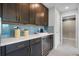 Chic wet bar features sleek cabinetry, a wine fridge, and stylish backsplash for entertaining at 628 Mystic Gardens Dr, Apopka, FL 32703