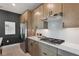 This modern kitchen features stainless steel appliances and elegant countertops with updated cabinets at 636 Mystic Gardens Dr, Apopka, FL 32703