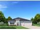 Charming single-story home with a three-car garage and manicured lawn on a sunny day at 10919 Sw 73Rd Ct, Ocala, FL 34476