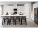 Stylish kitchen with sleek white cabinets, a central island with barstools, and modern appliances at 10919 Sw 73Rd Ct, Ocala, FL 34476
