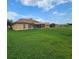 Expansive backyard with lush green grass, providing ample space for outdoor activities at 3612 Northwoods Dr, Kissimmee, FL 34746