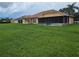 Large grassy backyard with screened-in lanai, ideal for outdoor enjoyment and privacy at 3612 Northwoods Dr, Kissimmee, FL 34746