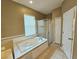 Bright bathroom featuring a jacuzzi tub, walk-in shower, tile floors and neutral wall color at 3612 Northwoods Dr, Kissimmee, FL 34746