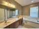Bathroom features double vanity, soaking tub, walk-in shower and great natural light at 3612 Northwoods Dr, Kissimmee, FL 34746