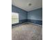 Spacious bedroom featuring carpet flooring, an accent wall, and ample natural light at 3612 Northwoods Dr, Kissimmee, FL 34746