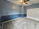 Bedroom with plush carpet flooring, ceiling fan and blue accent wall at 3612 Northwoods Dr, Kissimmee, FL 34746