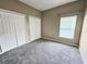 Bedroom featuring two closets, neutral colored walls, carpet and natural light at 3612 Northwoods Dr, Kissimmee, FL 34746