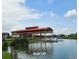 Community boat lift on the lake for convenient access to water activities, surrounded by lush landscaping at 3612 Northwoods Dr, Kissimmee, FL 34746