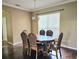 Traditional dining room with a classic wood table, six chairs, and dark hardwood floors at 3612 Northwoods Dr, Kissimmee, FL 34746