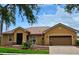Attractive home showcasing its tile roof, well-maintained landscaping, and two-car garage with paver driveway at 3612 Northwoods Dr, Kissimmee, FL 34746