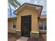 Close-up of the front entrance featuring a screened-in porch and stone accents at 3612 Northwoods Dr, Kissimmee, FL 34746