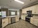 Modern kitchen featuring stainless steel appliances, granite countertops, and wood-look flooring at 3612 Northwoods Dr, Kissimmee, FL 34746