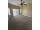 Spacious primary bedroom showcasing carpet, ample lighting and sliding glass doors at 3612 Northwoods Dr, Kissimmee, FL 34746
