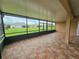 Screened-in patio with tile flooring offers an outdoor living space and backyard views at 3612 Northwoods Dr, Kissimmee, FL 34746
