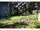 The backyard has a green open space with some trees, plants and a fence at 5635 Kimball Rd, Mulberry, FL 33860