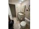 A cozy bathroom featuring a vanity with a sink, medicine cabinet, and a toilet, all neatly arranged with tile flooring at 5635 Kimball Rd, Mulberry, FL 33860