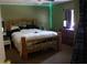 Bedroom with wood frame bed, dresser, and TV at 5635 Kimball Rd, Mulberry, FL 33860