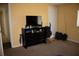 Functional bedroom with a chest of drawers, TV, and ample storage at 5635 Kimball Rd, Mulberry, FL 33860