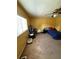 Bedroom showcasing carpet, window with blinds, ceiling fan, and a single bed with a blue bedspread at 5635 Kimball Rd, Mulberry, FL 33860