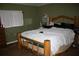 Cozy bedroom featuring a distinctive wooden bed frame and neutral walls at 5635 Kimball Rd, Mulberry, FL 33860