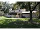 Exterior showcasing a two-story home, attached garage, and a screened porch at 5635 Kimball Rd, Mulberry, FL 33860