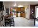 Spacious kitchen equipped with wooden cabinets, white appliances, and tile flooring at 5635 Kimball Rd, Mulberry, FL 33860
