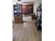 Living room featuring wood-look floors, opening into dining space at 5635 Kimball Rd, Mulberry, FL 33860