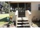 Exterior view of the screened in porch with wood stairs at 5635 Kimball Rd, Mulberry, FL 33860