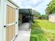 Backyard with storage shed, covered patio, and well-maintained lawn at 774 Hendrix Ave, Orlando, FL 32825