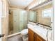 Bathroom features a shower with glass doors, tiled walls, and vanity with a large mirror at 774 Hendrix Ave, Orlando, FL 32825