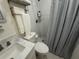 Clean bathroom with a white marble countertop, tiled shower, and convenient towel storage at 774 Hendrix Ave, Orlando, FL 32825
