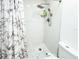 Shower stall with marble shower curtain, rainfall showerhead, and a pebble tile floor at 774 Hendrix Ave, Orlando, FL 32825