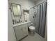Bright bathroom featuring a shower with a gray curtain and white vanity with marble countertop at 774 Hendrix Ave, Orlando, FL 32825