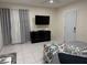 Bedroom featuring grey tile floors and a flat-screen tv at 774 Hendrix Ave, Orlando, FL 32825