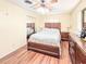 Bedroom featuring hardwood floors, a ceiling fan, mirrored closet doors, and neutral wall paint at 774 Hendrix Ave, Orlando, FL 32825