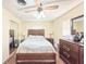 Bedroom featuring hardwood floors, a ceiling fan, mirrored closet doors, and neutral wall paint at 774 Hendrix Ave, Orlando, FL 32825
