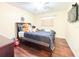 Bedroom with hardwood floors features a black bedframe and neutral walls at 774 Hendrix Ave, Orlando, FL 32825