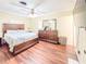 Bedroom features hardwood floors, a ceiling fan, and mirrored closet doors at 774 Hendrix Ave, Orlando, FL 32825