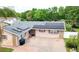 Charming single-story home featuring solar panels, brick accents, and a spacious brick driveway at 774 Hendrix Ave, Orlando, FL 32825