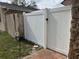 Backyard featuring a new white vinyl fence with a brick walkway at 774 Hendrix Ave, Orlando, FL 32825