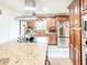 Spacious kitchen featuring granite counters, island cooktop, stainless steel appliances, and ample cabinetry at 774 Hendrix Ave, Orlando, FL 32825