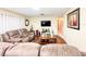 Comfortable living room featuring hardwood floors, a plush sofa, and modern wall-mounted television at 774 Hendrix Ave, Orlando, FL 32825