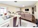 Connected spaces with tile and hardwood floors, plus a dining table and cozy seating in the living room at 774 Hendrix Ave, Orlando, FL 32825