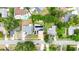 Aerial view of a neighborhood showcasing a home with solar panels, surrounded by mature trees and lush landscaping at 774 Hendrix Ave, Orlando, FL 32825