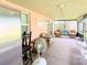 Spacious screened porch featuring wicker furniture, a ceiling fan, and lots of room for outdoor living at 774 Hendrix Ave, Orlando, FL 32825