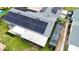 This home features an array of solar panels on the roof, along with an enclosed porch at 774 Hendrix Ave, Orlando, FL 32825