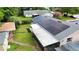 An aerial view of a house with solar panels installed, complemented by well-maintained landscaping at 774 Hendrix Ave, Orlando, FL 32825