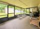 Enclosed sunroom with seating and view of backyard at 774 Hendrix Ave, Orlando, FL 32825